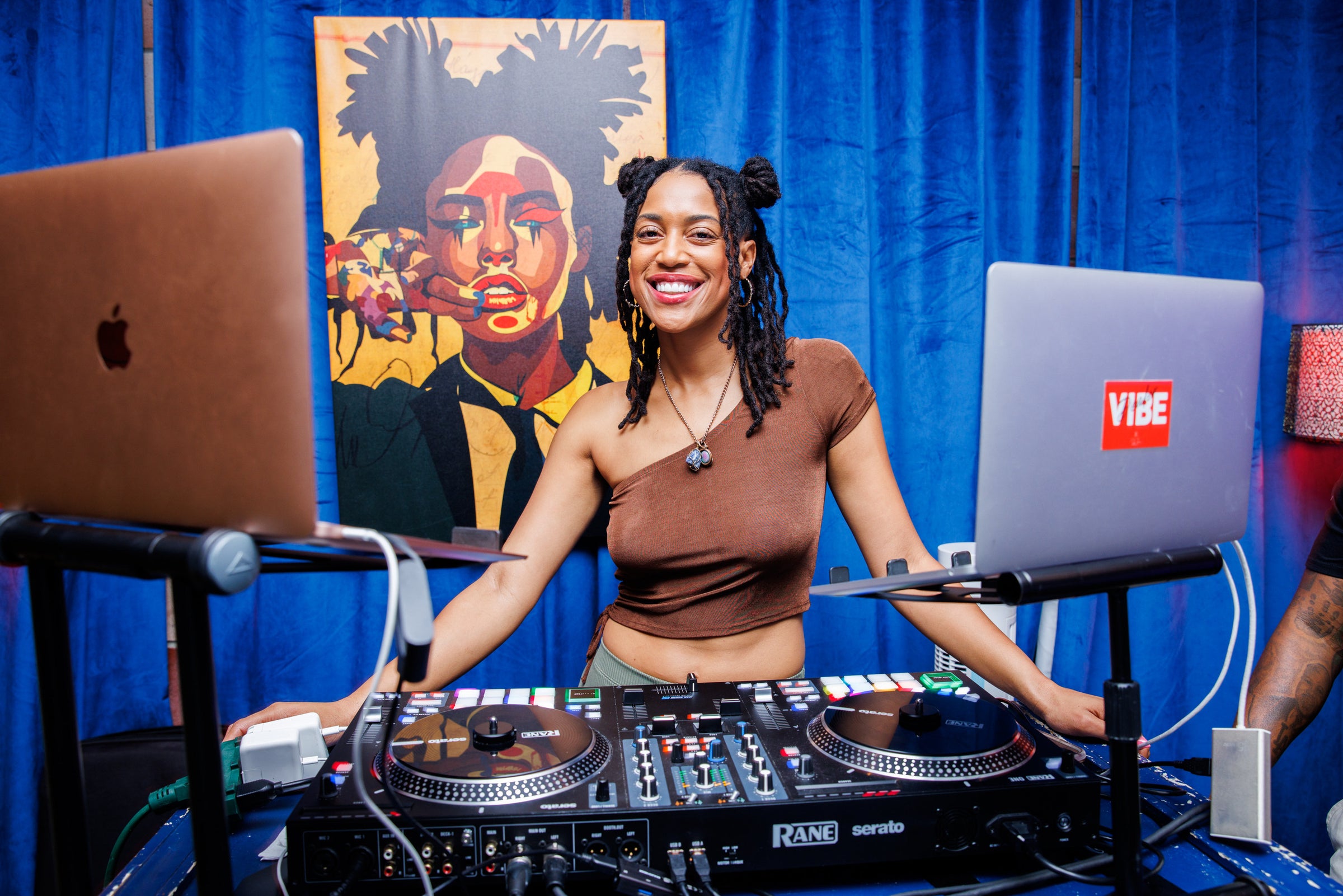 DJ Jess, the Vibe Dealer in front of her turn tables